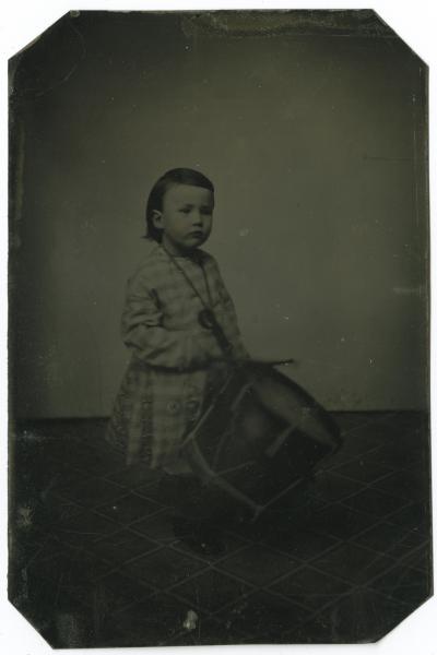 Clarke as a child with a drum