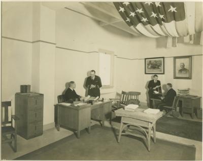 Clarke at his Long Beach office with three other men.