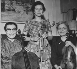 Polly Pettinga (cello), Bettye Krolick (violin), and Mary Kelly (viola), at the home of Mrs. Russell