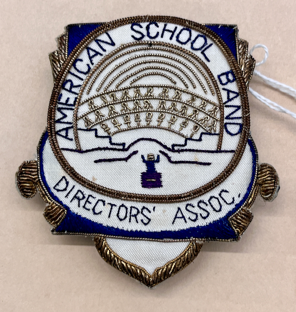 An embroidered patch with the words American School Band Directors' Assoc. and the organization's logo.