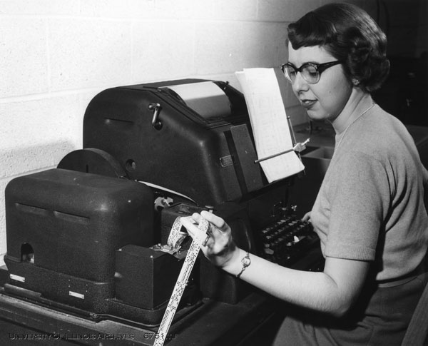Computer typewriter operator Caroline Brown punches data and instructions on paper tape which is could be processed by ILLIAC at two feet/second (1954). Found in Record Series 39/2/20, Box 177.